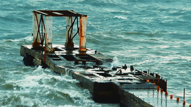 Video 1920x1080 - Old breakwater during a heavy storm. Waves splashing into the air through the holes in the concrete structure.