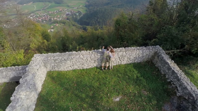 Couple looking at the view of a village 