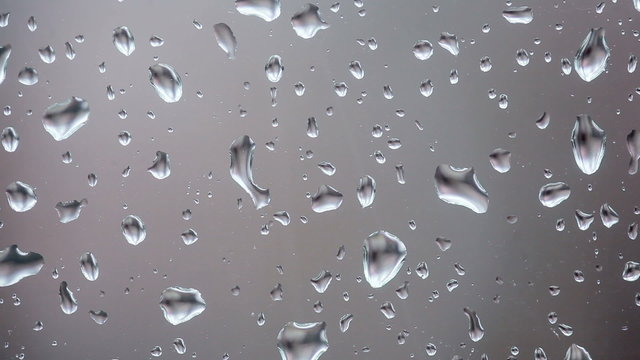 Raindrops running down a windowpane