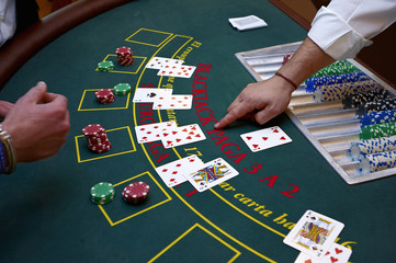 A close up of a blackjack dealer's hands in a casino, very shallow depth of field