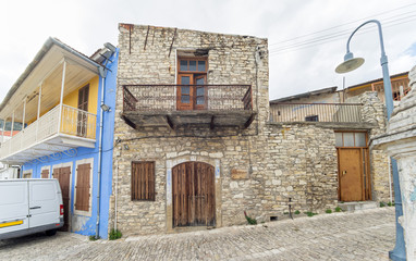 Fisheye view on medieval pavement street with stonemasonry building. Pano Lefkara, Cyprus.
