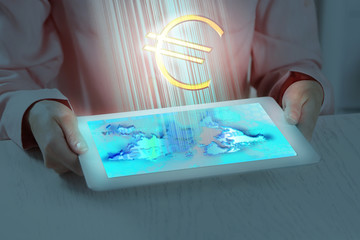 Woman holding digital tablet with euro sign