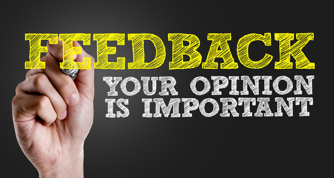 Hand writing the text: Feedback - Your Opinion Is Important
