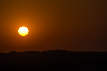 Fototapeta na wymiar Red sunset over the dunes- Dubai