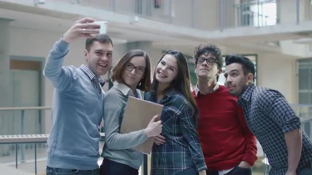 Group of young multi-ethnic students are making selfie pictures in an university. Shot on RED Cinema Camera.