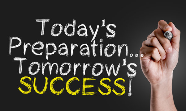 Hand writing the text: Todays Preparation... Tomorrows Success!