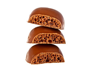 Pieces of tile porous milk chocolate on white background