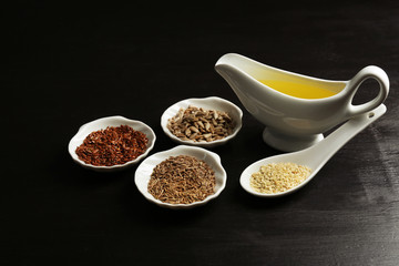 Different kinds of seeds and oil on wooden table