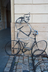 Parking for bicycle with forged metal known literary character - Soldier Schweik. Lviv, Ukraine