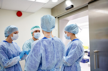 group of surgeons in operating room at hospital