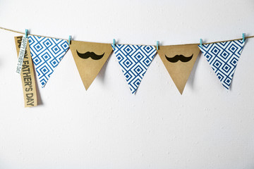 Triangle garland with mustache and pattern on wall