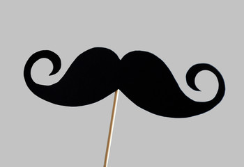 Black mustache on wooden stick, closeup - Powered by Adobe