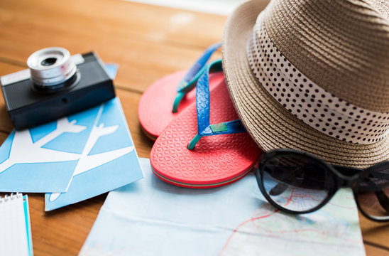 close up of travel map, flip-flops, hat and camera