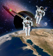 Two astronauts spaceman saturn planet spacewalk outer space walk moon universe. Elements of this image furnished by NASA. - 105111690