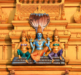 Lord Vishnu statue on exterior architecture of hindu temple