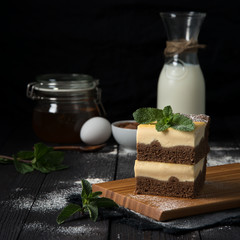 chocolate cheesecake with vanilla filling on a dark background