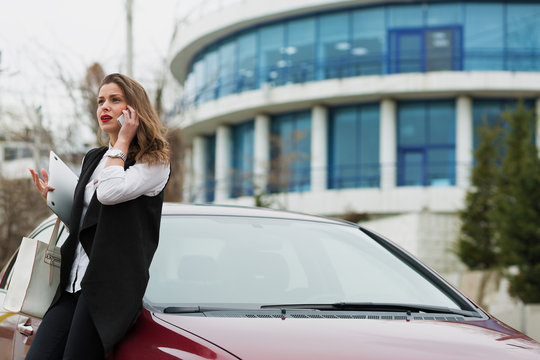 Business woman standing near her car