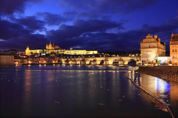 Colorful Prague gothic Castle above the River Vltava with Charles Bridge in the Evening, Czech...