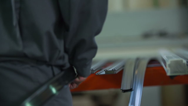 Worker puts flexible belt to special frame