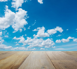 wooden table top with beautiful sky with clouds