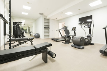 Fototapeta na wymiar Modern gym interior with equipment