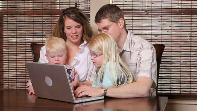 Family looking at laptop computer together