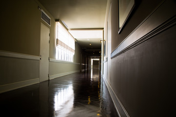 Dark and empty corridor with available natural light from window