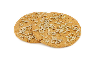 crispy spelt crackers with sunflower seeds on a white background