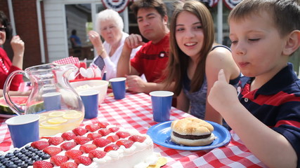 Boy tastes cake and smiles - Powered by Adobe