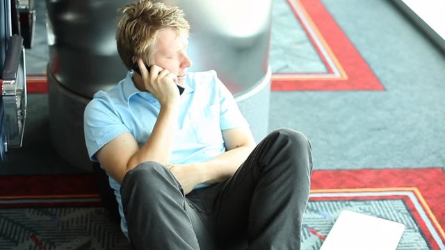 Man talking on cellphone in airport