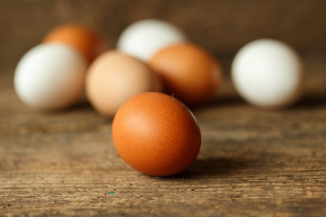 Chicken eggs on a wooden rustic background