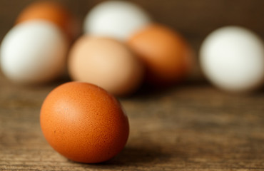 Chicken eggs on a wooden rustic background