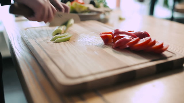 Chef chopping vegetables on a cutting board