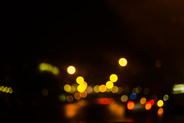 Colorful defocused bokeh lights background. City glare abstract background.