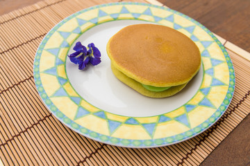 Piece of Dorayaki - delicious sweets of Japanese Traditional Dessert : Dorayaki in dish on wooden background
