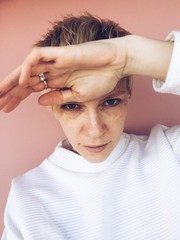 Portrait of young blonde woman, white short hair, tomboy style daylight