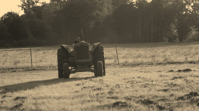 Farmer driving tractor in field