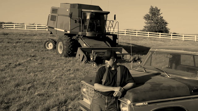 Portrait of farmer standing by pickup truck