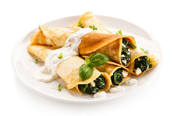 Crepes with spinach and feta cheese on white background  - obrazy, fototapety, plakaty