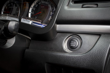start and stop button in the car, selective focused, dark toned