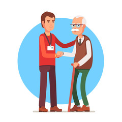 Social worker helping elder grey haired man