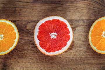 Fototapeta na wymiar Fresh Orange and Grapefruit on Wooden Background
