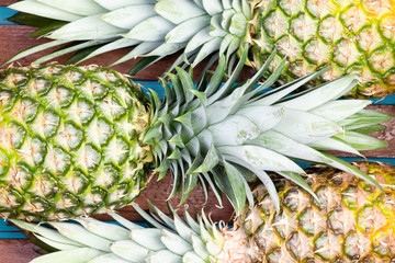 Three pineapple fruits close together