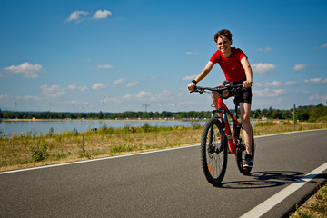 Urban biking - teenage boy riding bike 