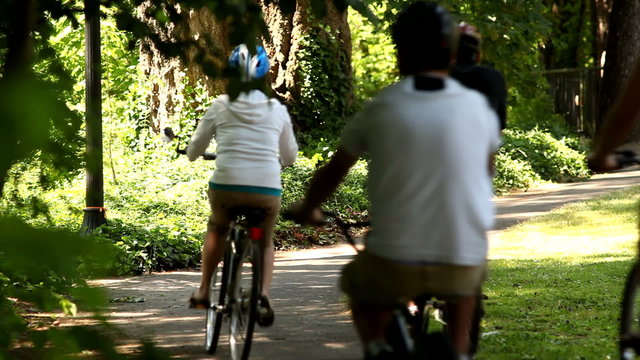 Family riding bicycles down path