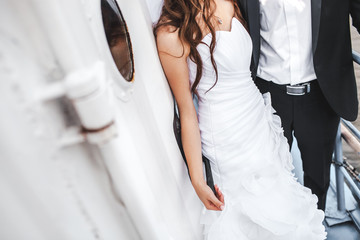 Wedding bride and groom on deck of boat, stylish couple.