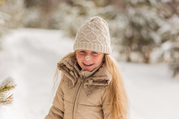 Girl laughing with snow on her nose
