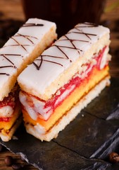 Two portions of sweet dessert on black stone