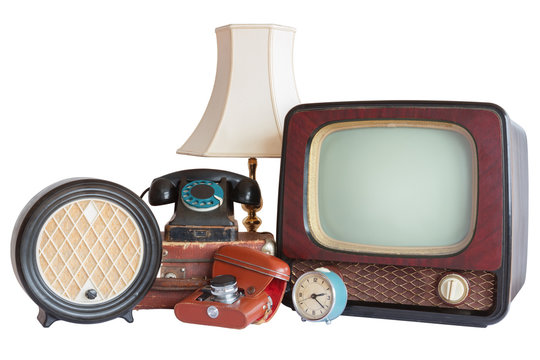 Old household items: TV, radio, camera, alarm, phone, table lamp