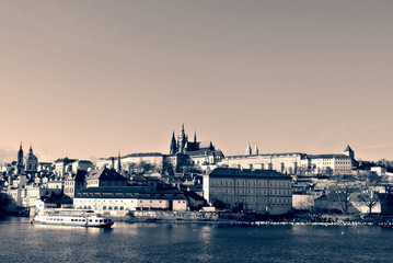 Obraz premium Hradcany castle in Prague seen from the river, in black and white. Monochrome image filtered in retro, vintage style with soft focus and red filter; high contrast dramatic effect.
